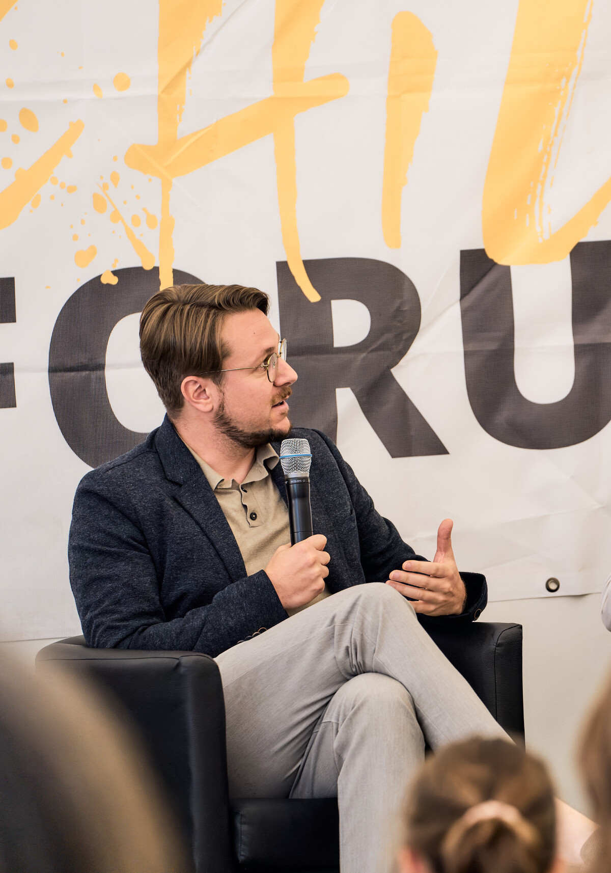 Landammann Philipp Wilhelm, the mayor of Davos, in conversation in front of the World Child Forum banner
