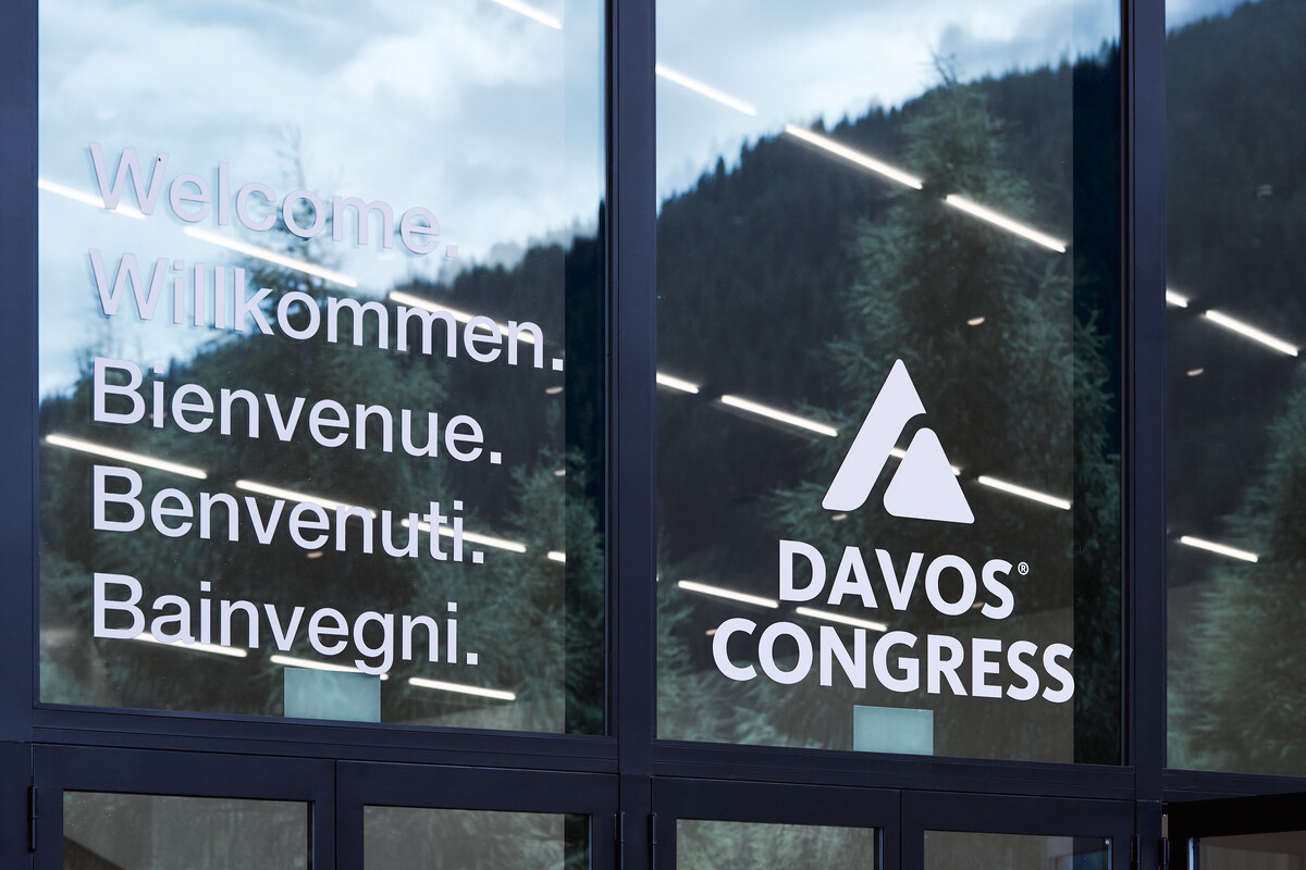 Windows of the Davos Congress Centre greeting visitors with 'Welcome' in five languages