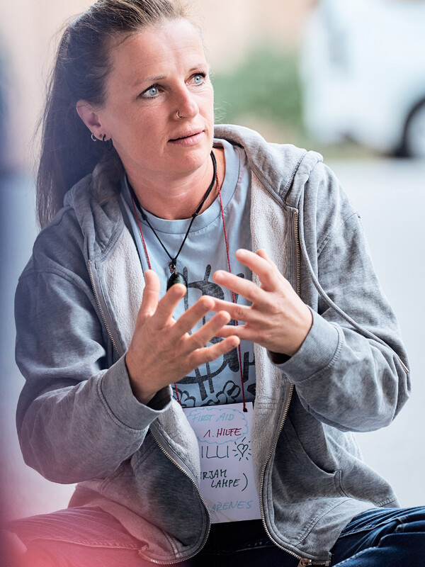 A workshop participant in a World Child Forum shirt speaks with her hands